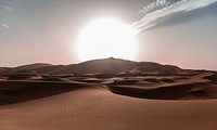 Sun rides over rolling sand dunes of the Sahara Desert. Original public domain image from Wikimedia Commons