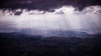 A vast rural landscape under faint light seeping in from the clouds. Original public domain image from <a href="https://commons.wikimedia.org/wiki/File:Faint_sunlight_and_countryside_(Unsplash).jpg" target="_blank" rel="noopener noreferrer nofollow">Wikimedia Commons</a>