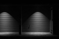 Black and white shot of wooden wall with light and shadow and door. Original public domain image from Wikimedia Commons