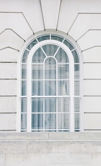 A white arched window in a building in London. Original public domain image from <a href="https://commons.wikimedia.org/wiki/File:White_arched_window_(Unsplash).jpg" target="_blank" rel="noopener noreferrer nofollow">Wikimedia Commons</a>