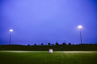 A grass football field in the middle of the evening. Original public domain image from Wikimedia Commons