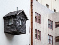 Wooden shed cabin stuck on apartment wall in Sutter Street. Original public domain image from <a href="https://commons.wikimedia.org/wiki/File:Cabin_on_exterior_of_building_(Unsplash).jpg" target="_blank" rel="noopener noreferrer nofollow">Wikimedia Commons</a>