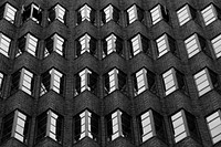 Black and white shot of jagged wall architecture with windows in Pitt Street. Original public domain image from <a href="https://commons.wikimedia.org/wiki/File:Pitt_Street,_Sydney,_Australia_(Unsplash).jpg" target="_blank" rel="noopener noreferrer nofollow">Wikimedia Commons</a>