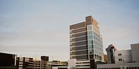 Office buildings and multi-story parking lots in Newark. Original public domain image from <a href="https://commons.wikimedia.org/wiki/File:White_office_building_(Unsplash).jpg" target="_blank" rel="noopener noreferrer nofollow">Wikimedia Commons</a>