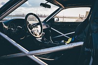 Interior of race car with reinforced door and steering wheel. Original public domain image from Wikimedia Commons