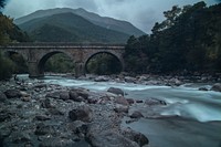 A fascinating shot of a bridge and underlying river in Saint-Vincent-les-Forts. Original public domain image from Wikimedia Commons