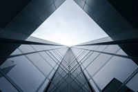 A glass building reflecting other buildings in the windows. Original public domain image from Wikimedia Commons