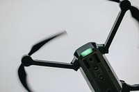 A close-up of a black DJI drone in flight. Original public domain image from <a href="https://commons.wikimedia.org/wiki/File:Blades_(Unsplash).jpg" target="_blank" rel="noopener noreferrer nofollow">Wikimedia Commons</a>