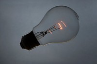 Wireless light bulb with glowing filament inside. Original public domain image from Wikimedia Commons