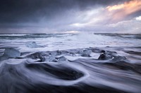 A cloudy sunrise above splashing sea waves in Jökulsárlón. Original public domain image from <a href="https://commons.wikimedia.org/wiki/File:Sunrise_on_the_ocean_in_J%C3%B6kuls%C3%A1rl%C3%B3n_(Unsplash).jpg" target="_blank" rel="noopener noreferrer nofollow">Wikimedia Commons</a>