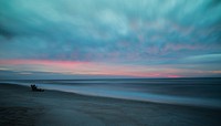 People on the sandy beach after the sunset at Saint Augustine Beach. Original public domain image from Wikimedia Commons