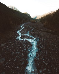 A frozen riverbed in the forest in winter. Original public domain image from Wikimedia Commons