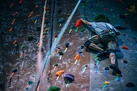 Athletes climb rock wall and use ropes and grip rocks. Original public domain image from Wikimedia Commons