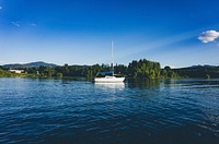 A small sailboat on a tranquil lake. Original public domain image from Wikimedia Commons