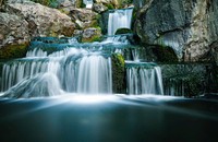 Waterfall tumbling down from rocks. Original public domain image from Wikimedia Commons