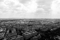 A black and white photo of the Paris cityscape on a cloudy day.. Original public domain image from Wikimedia Commons