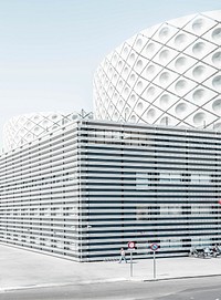 Man walking beside architectural building. Original public domain image from Wikimedia Commons