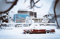 Red truck covered in snow at a harbor in Portland. Original public domain image from <a href="https://commons.wikimedia.org/wiki/File:Snow_days_(Unsplash).jpg" target="_blank" rel="noopener noreferrer nofollow">Wikimedia Commons</a>
