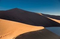 Sand dunes and ridges in the desert at sundown. Original public domain image from Wikimedia Commons