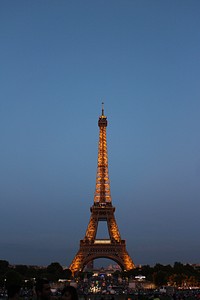 The Eiffel Tower monument with the Paris cityscape in the background.. Original public domain image from <a href="https://commons.wikimedia.org/wiki/File:Eiffel_Tower_at_night_(Unsplash_U1_qOdWE440).jpg" target="_blank" rel="noopener noreferrer nofollow">Wikimedia Commons</a>