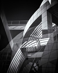 An arched gray terrace reflected in a window. Original public domain image from <a href="https://commons.wikimedia.org/wiki/File:Getty_center_architecture_(Unsplash).jpg" target="_blank" rel="noopener noreferrer nofollow">Wikimedia Commons</a>