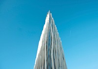 The edge of a tall narrow building with a modern facade. Original public domain image from Wikimedia Commons