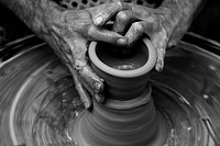Messy hands sculpting on a pottery wheel in motion. Original public domain image from <a href="https://commons.wikimedia.org/wiki/File:Pottery_wheel_(Unsplash).jpg" target="_blank" rel="noopener noreferrer nofollow">Wikimedia Commons</a>