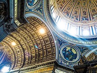 Ornate ceiling architecture in church with religious artwork, dome and light, St Peter's Basilica. Original public domain image from Wikimedia Commons