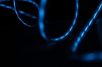 Blue light reflected in the surface of glossy swirling wires. Original public domain image from <a href="https://commons.wikimedia.org/wiki/File:Blue_light_on_glossy_wires_(Unsplash).jpg" target="_blank" rel="noopener noreferrer nofollow">Wikimedia Commons</a>