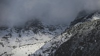 Clouds cover snowy mountains on a cold winter day. Original public domain image from <a href="https://commons.wikimedia.org/wiki/File:Frozen_fingers_(Unsplash).jpg" target="_blank" rel="noopener noreferrer nofollow">Wikimedia Commons</a>