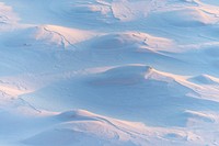 Mounds of snow covering the ground on a hill in Cherepovets, Russia. Original public domain image from <a href="https://commons.wikimedia.org/wiki/File:Snow_mountain_in_Russia_(Unsplash).jpg" target="_blank" rel="noopener noreferrer nofollow">Wikimedia Commons</a>
