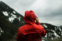 Person in a red jacket surveys a mountain landscape. Original public domain image from Wikimedia Commons