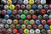 A colorful display of used spray paint cans in Berlin.. Original public domain image from Wikimedia Commons