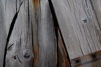 A close-up of weathered wooden planks with visible knots. Original public domain image from Wikimedia Commons