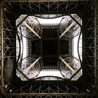 Street view looking inside the architecture of the Eiffel Tower in Paris, France.. Original public domain image from Wikimedia Commons