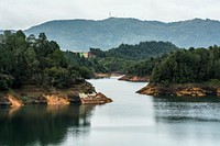 Big river with green island with mountain background. Original public domain image from Wikimedia Commons