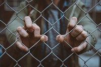 Macro view of an urban person's hand on a chain link fence in De Nieuwe Stad. Original public domain image from Wikimedia Commons