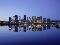 Cityscape by water during golden hour. Original public domain image from Wikimedia Commons