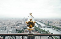 A telescope in front of a rail overlooking Paris and the Seine River. Original public domain image from <a href="https://commons.wikimedia.org/wiki/File:Telescope_overlooking_Paris_(Unsplash_bZXQ6zUmqkw).jpg" target="_blank" rel="noopener noreferrer nofollow">Wikimedia Commons</a>