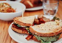 BLT sandwich at the table of an American deli restaurant. Original public domain image from <a href="https://commons.wikimedia.org/wiki/File:Sandwich_and_Sides_(Unsplash).jpg" target="_blank" rel="noopener noreferrer nofollow">Wikimedia Commons</a>