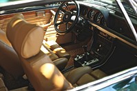 Interior shot of a vintage car with sunlight seeping in.. Original public domain image from Wikimedia Commons