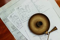 An old vintage candleholder on top of papers filled with handwritten notes in Portsmouth, England, United Kingdom. Original public domain image from Wikimedia Commons