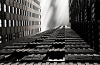 A black-and-white shot of skyscrapers with geometric patterns facade.. Original public domain image from <a href="https://commons.wikimedia.org/wiki/File:City_skyscraper_architecture_(Unsplash).jpg" target="_blank" rel="noopener noreferrer nofollow">Wikimedia Commons</a>