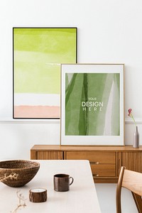 Picture frame mockups leaning against the wall in a dining room psd