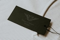 Label tag mockup, black paper with cherub logo for fashion business psd