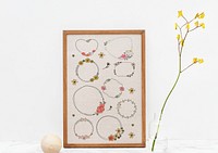 Hand drawn flower wreath set in a wooden frame mockup
