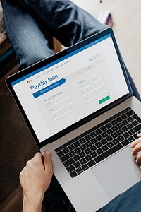 Man applying for a loan application on a laptop mockup during a coronavirus pandemic