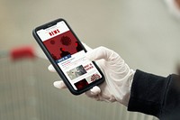 Woman wearing latex gloves reading the coronavirus news update on a mobile phone mockup 