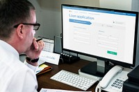 Businessman applying for a loan on a laptop mockup during the coronavirus pandemic