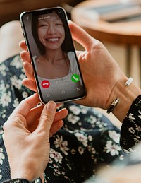 Woman video calling using a mobile phone mockup during the coronavirus pandemic